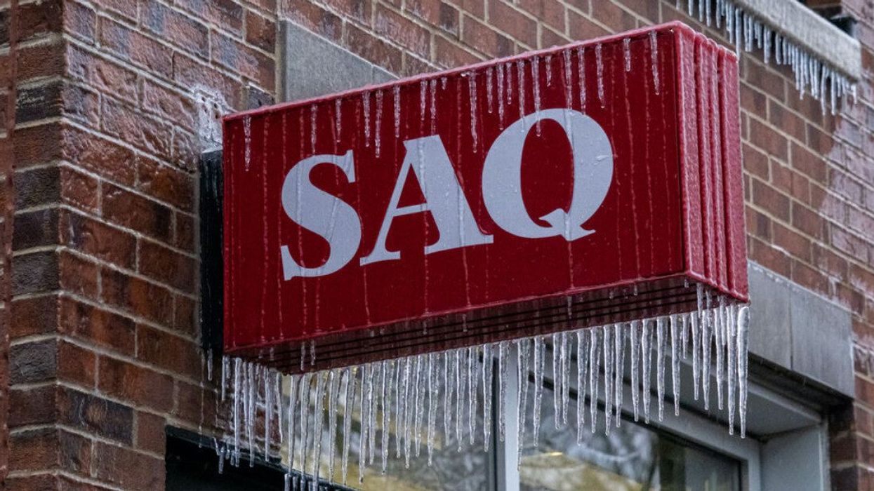 An SAQ sign covered in icicles.