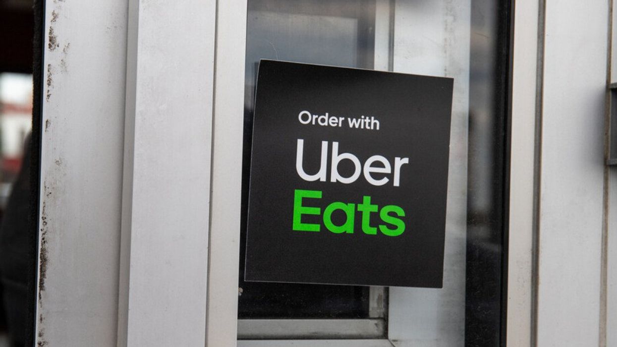 An Uber Eats sticker outside a restaurant.