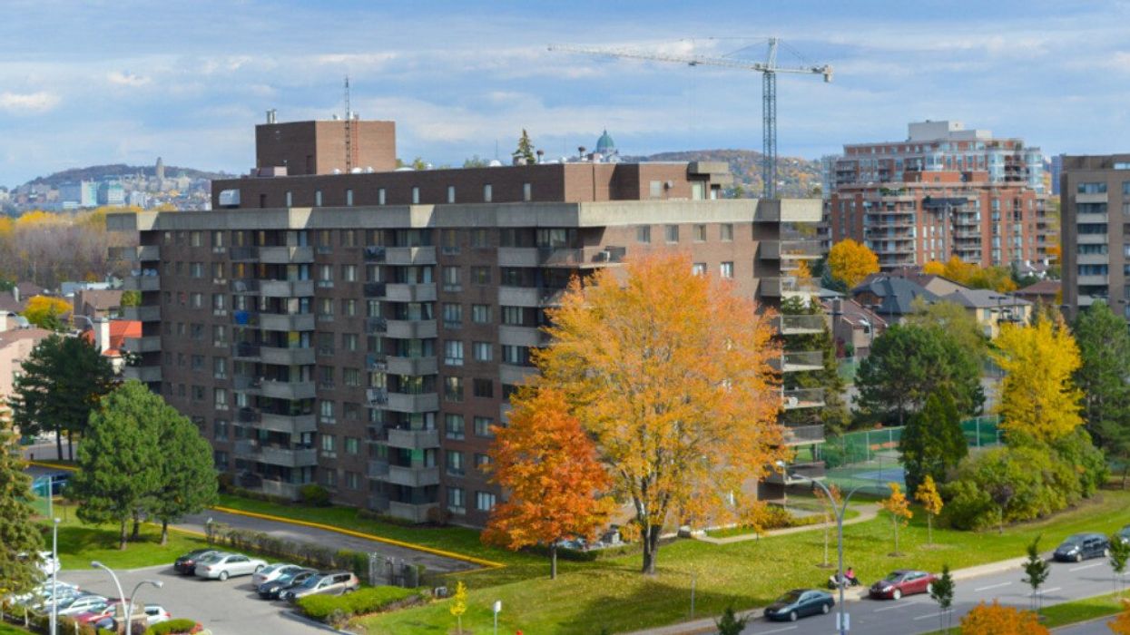 Apartment buildings in Côte Saint-Luc surrounded by colour-changing trees during the fall.