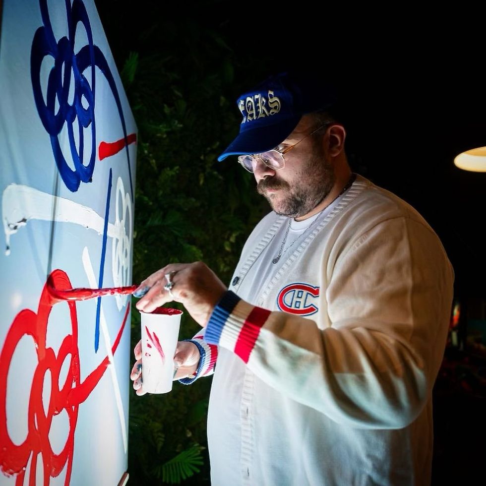 Artist Le Bicar as he paints.