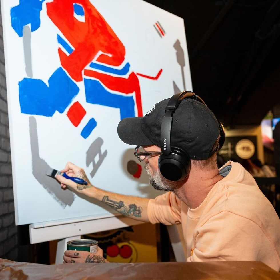 Artist Meka as he paints.