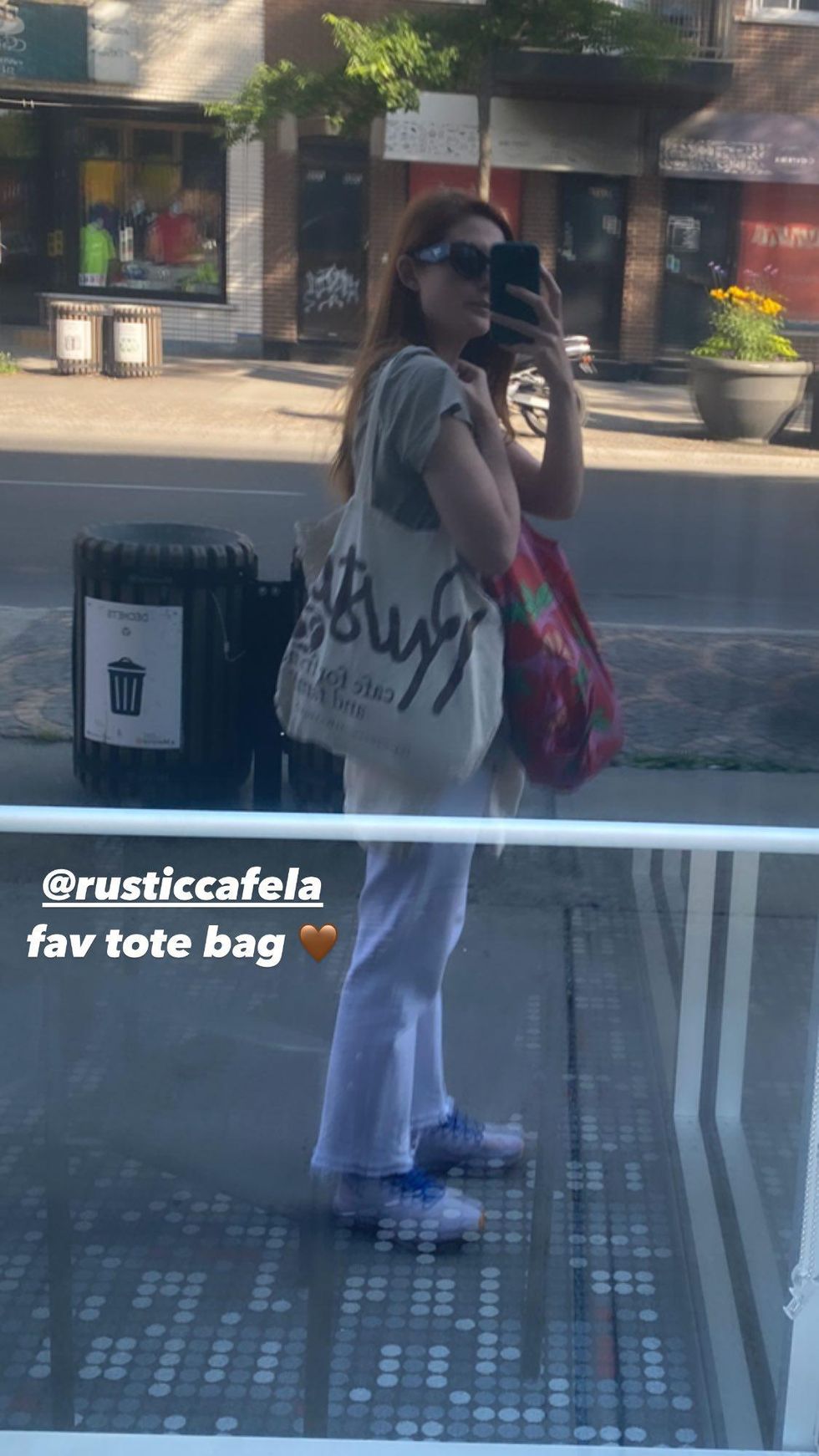 Bonne Wright takes a selfie in a Montreal shop window.