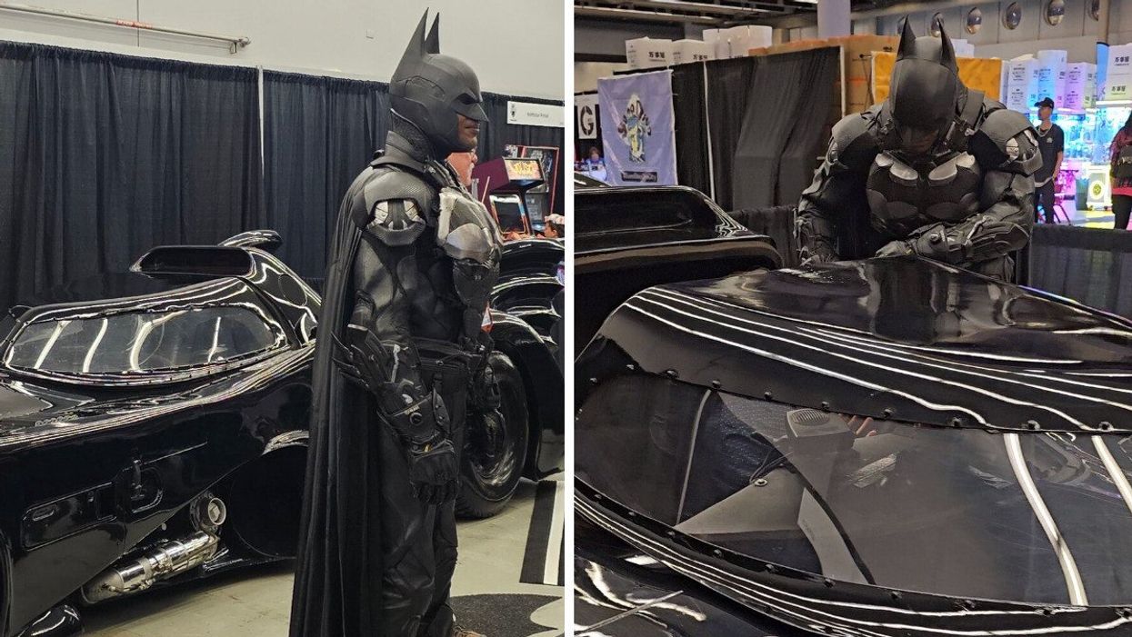 Brampton Batman stands next to his Batmobile at Montreal Comiccon.