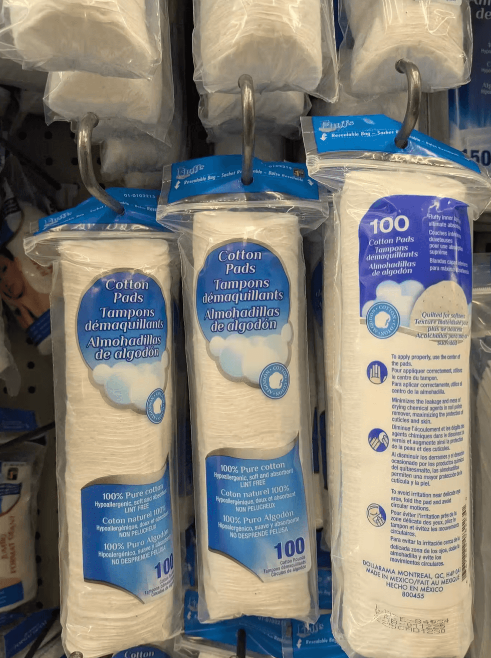 Buffs brand cotton pads hanging on a shelf at Dollarama.