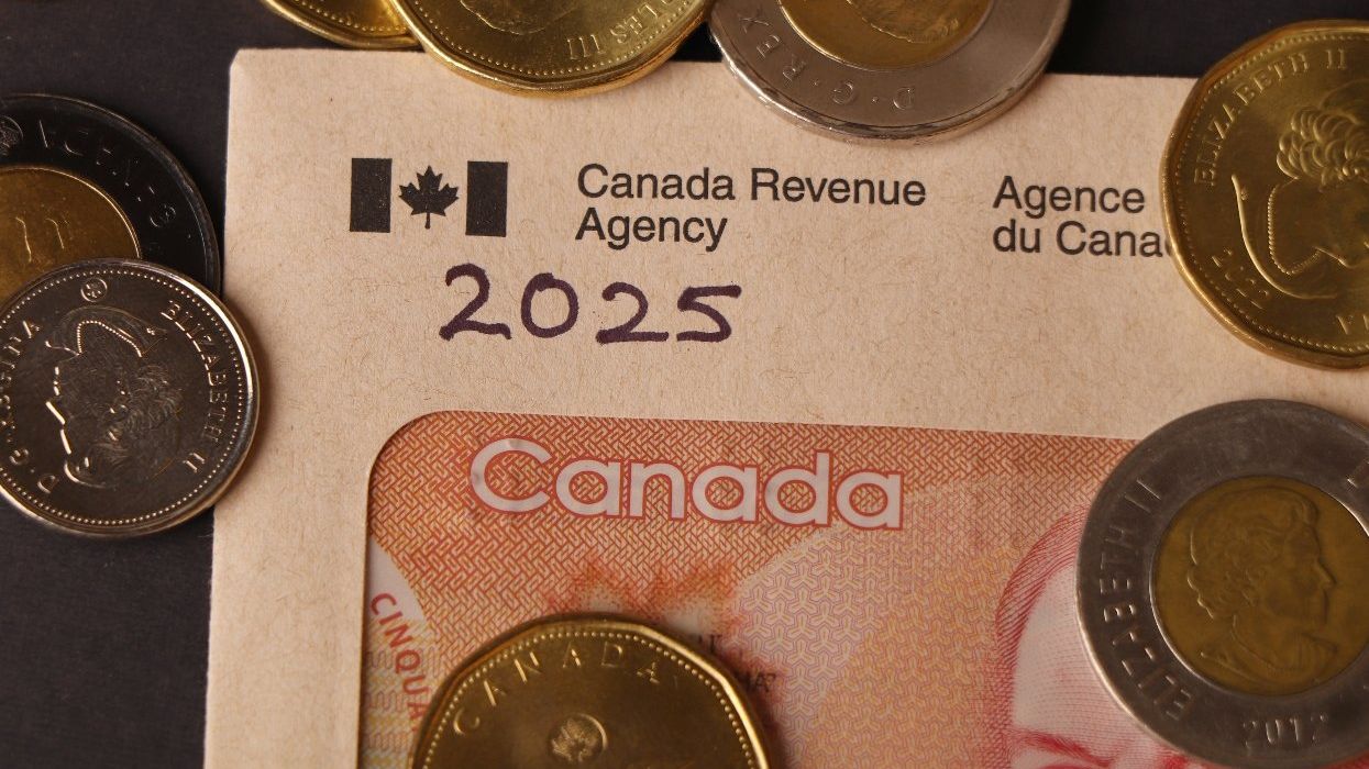 Canada Tax return concept with Canada revenue agency envelope and Canadian dollars.