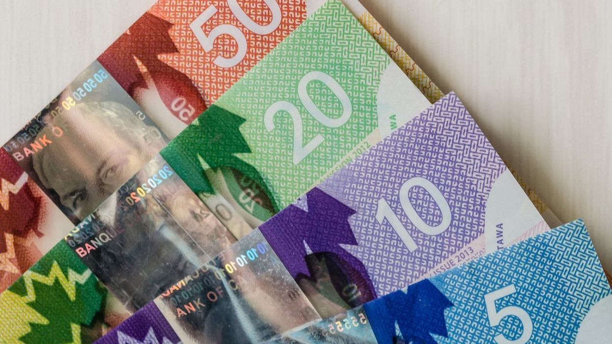 Canadian bank notes including a $5, $10, $20, and $50 bill.
