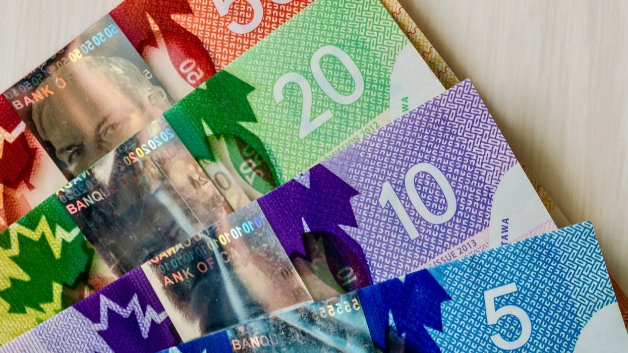 Canadian bank notes including a $50 bill, $20 bill, $10 bill and $5 bill.