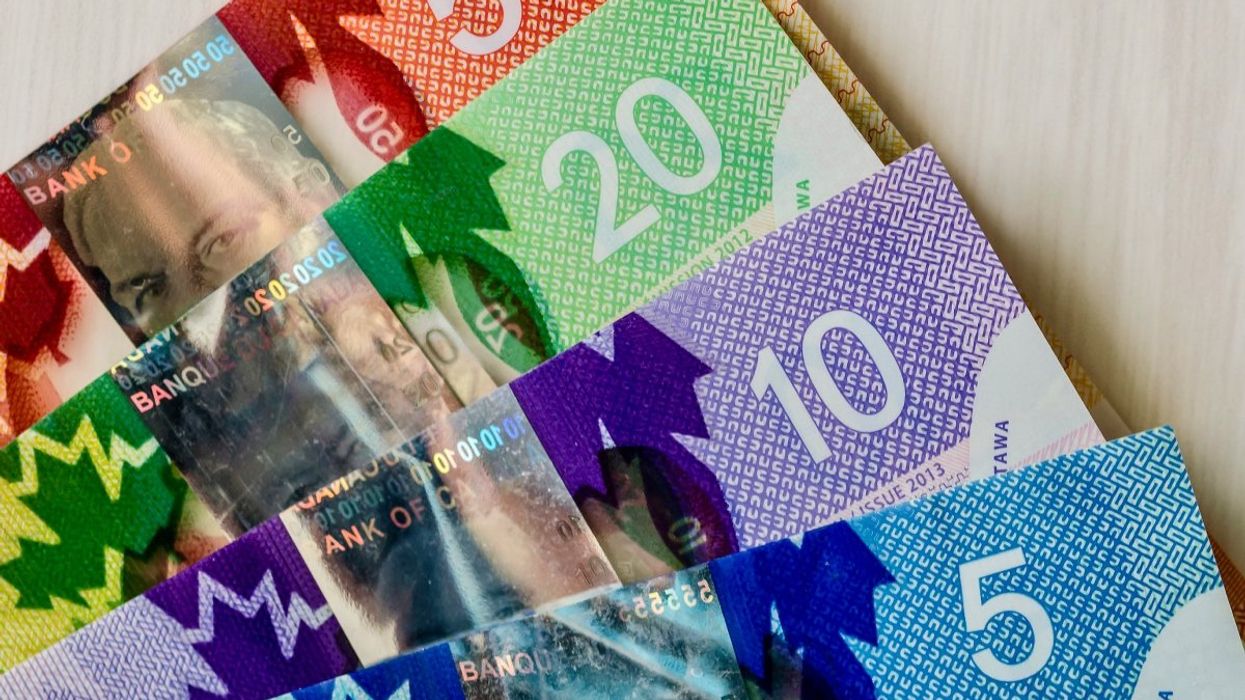 Canadian bank notes including a $50 bill, $20 bill, $10 bill and $5 bill.