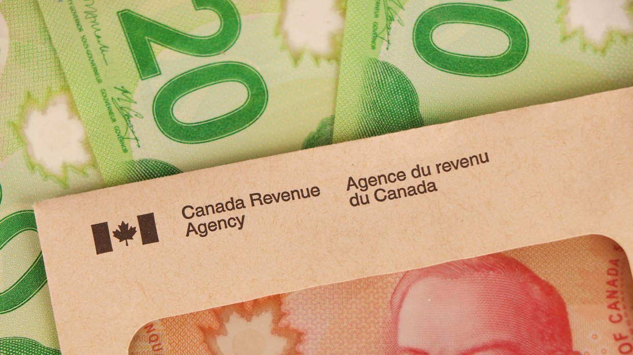 Canadian cash and a CRA envelope (illustrative).
