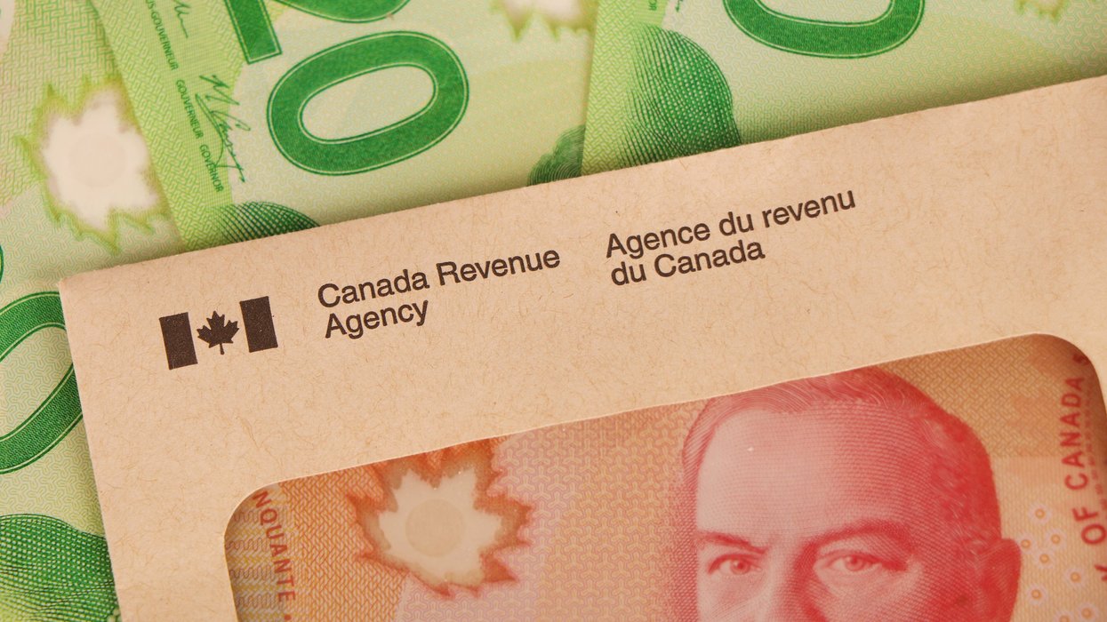 Canadian cash and a CRA envelope (illustrative).