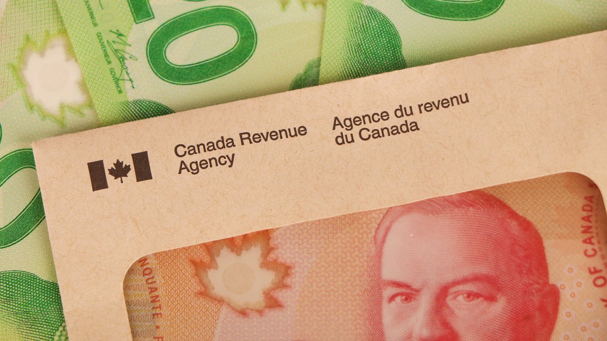 Canadian cash and a CRA envelope (illustrative).