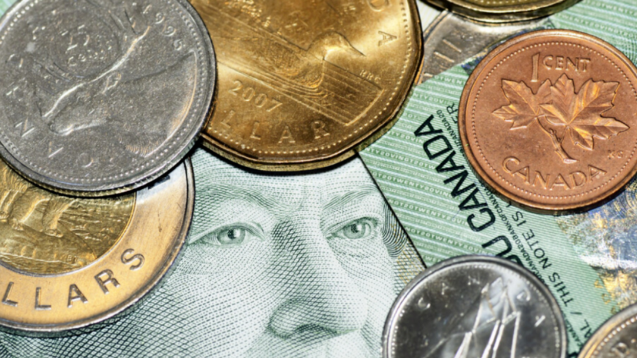 Canadian money: $20 bill surrounded by coins.
