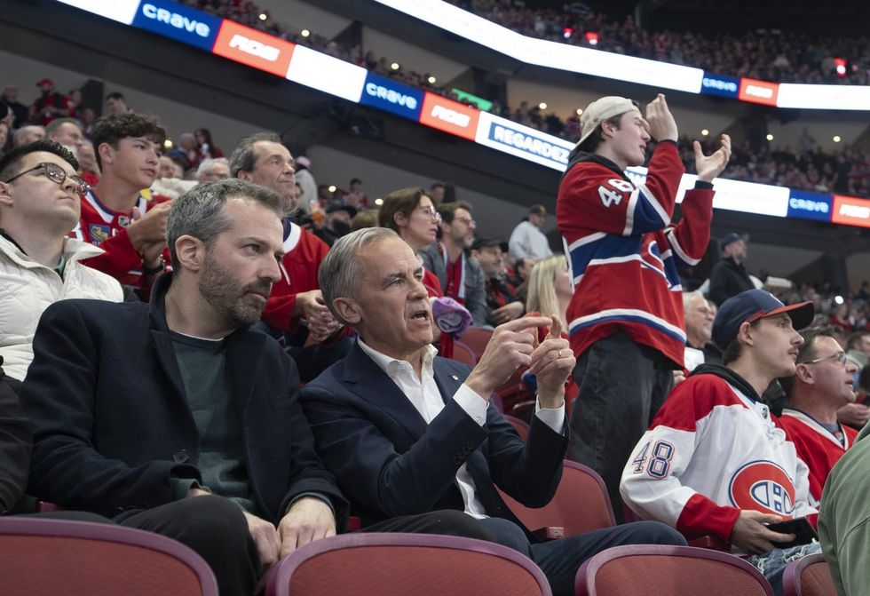 Carney watches a hockey game.