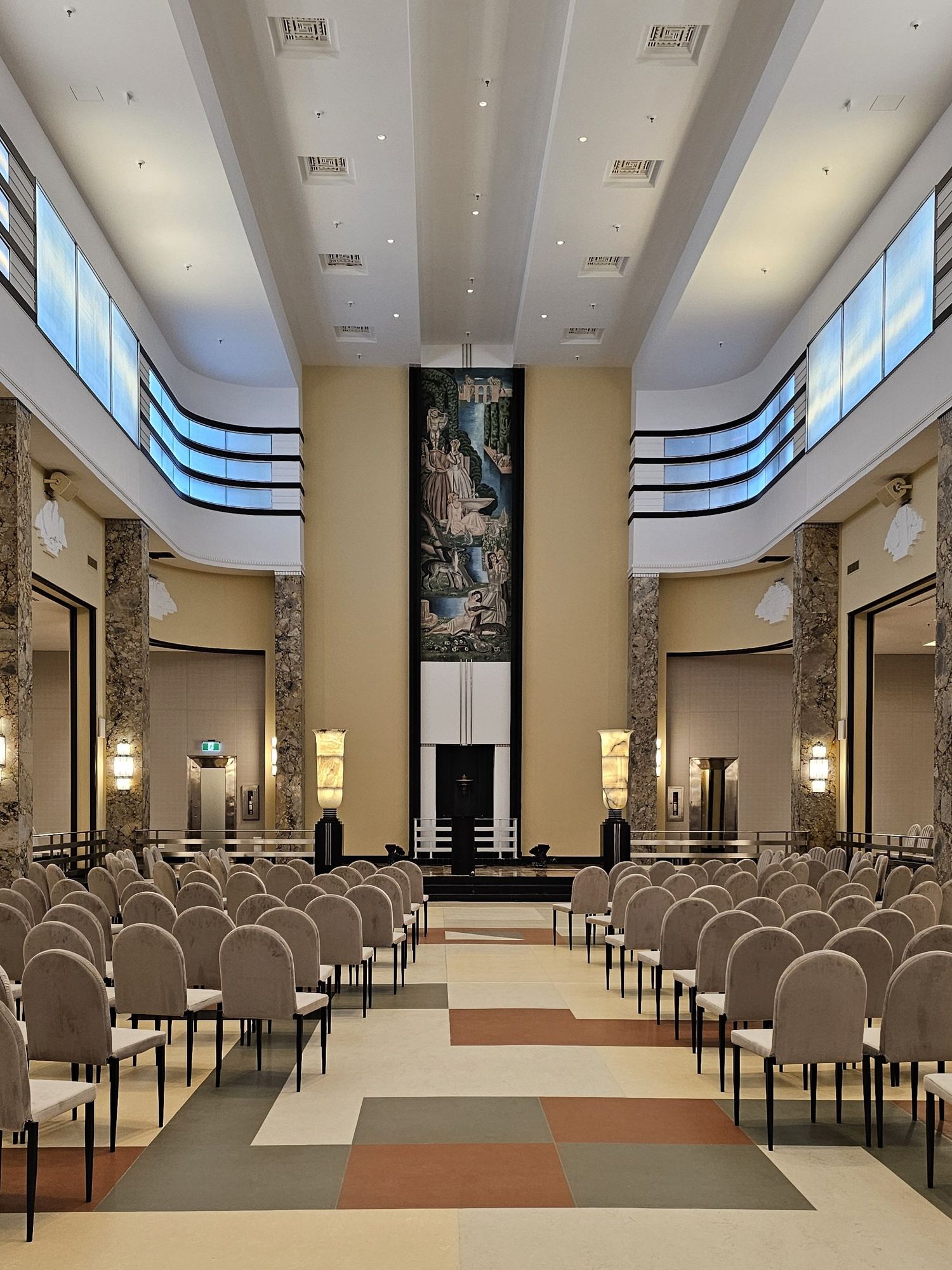 Chairs facing one mural in the dining room of Le 9e.