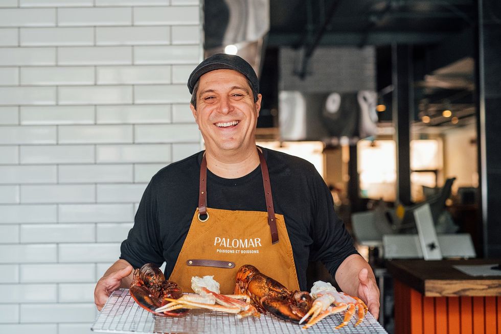 Chef Constant Mentzas with a tray of lobster and crab.