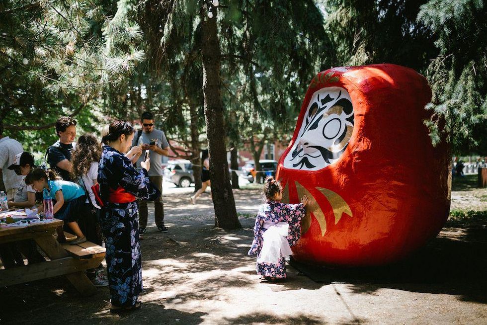 Child approaches a statue in a Montreal park.