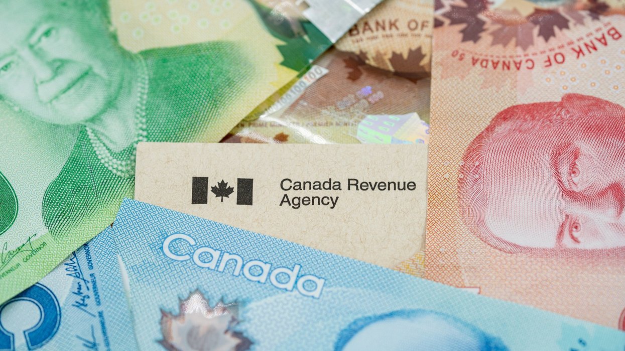Close up of Canada Revenue Agency document with Canadian banknotes, money (CRA). Toronto, Canada - September 18, 2025