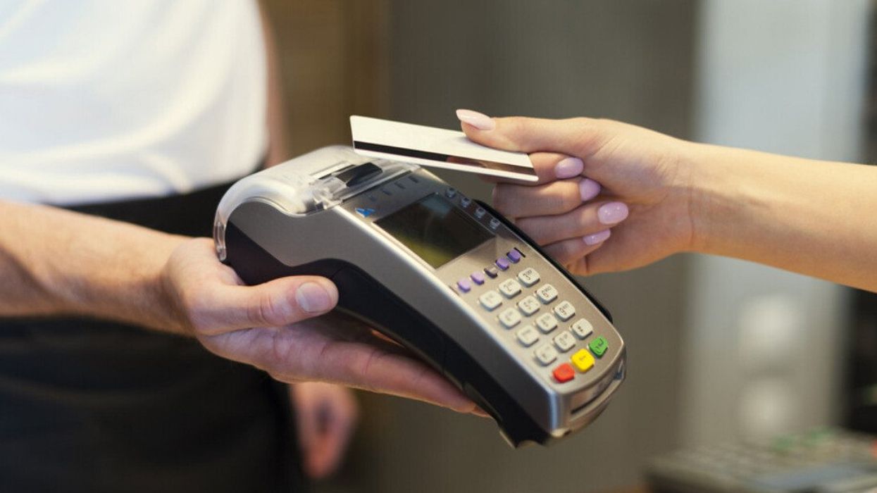 Close up of customer paying by credit card.