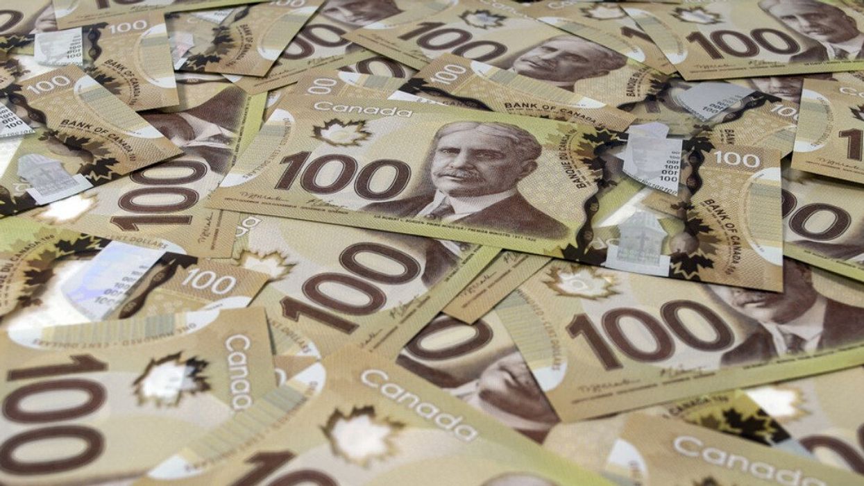 Close up view of 100 Canadian dollar banknotes.