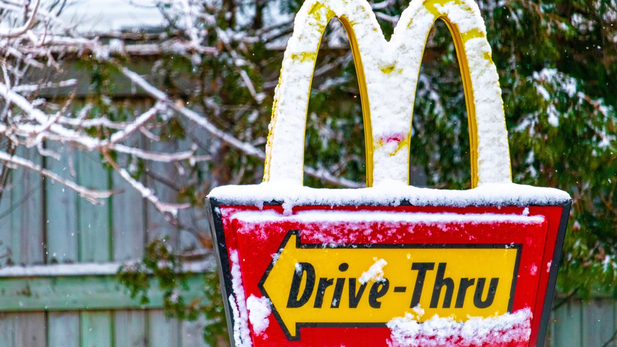 Closeup of a McDonald's drive-thru sign covered in snow.