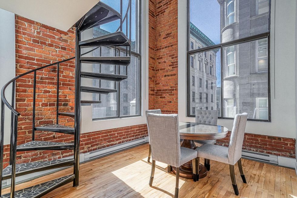 Condo dining room and spiral staircase.