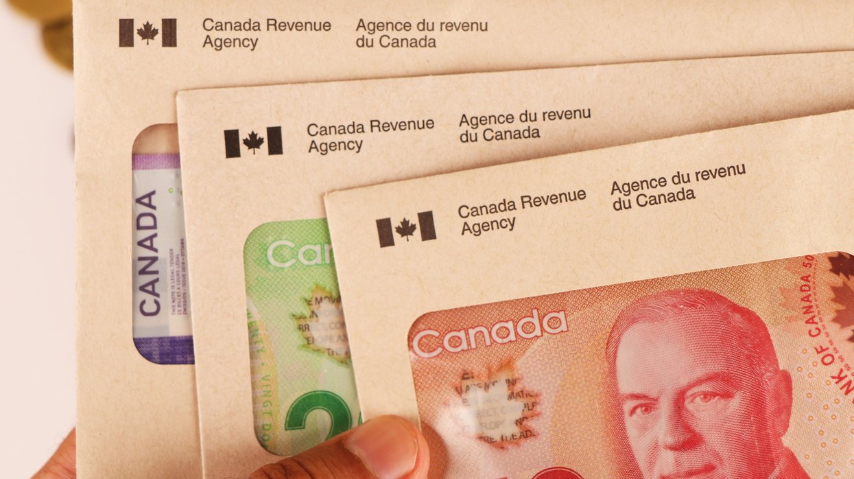 CRA envelopes and Canadian cash (illustrative).