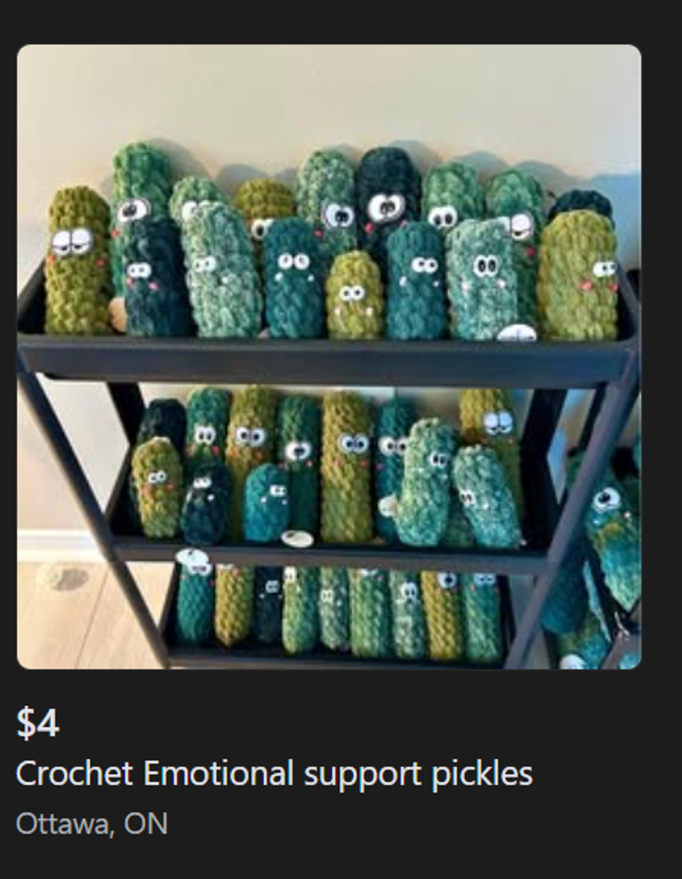 Crocheted pickles on a shelf.