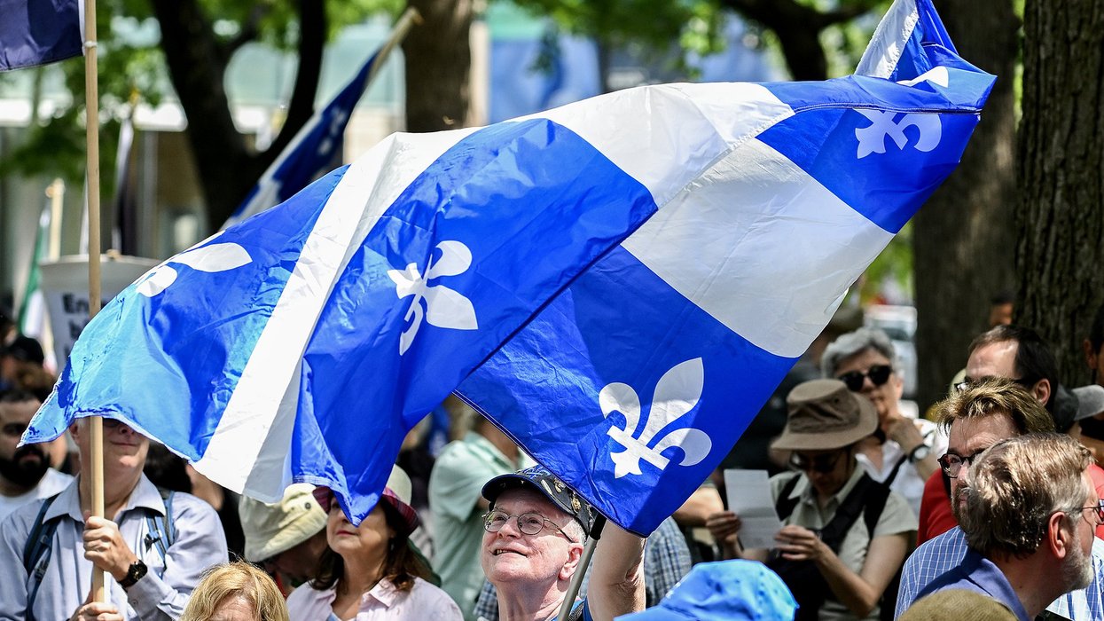 Crowd waving Quebec flags.