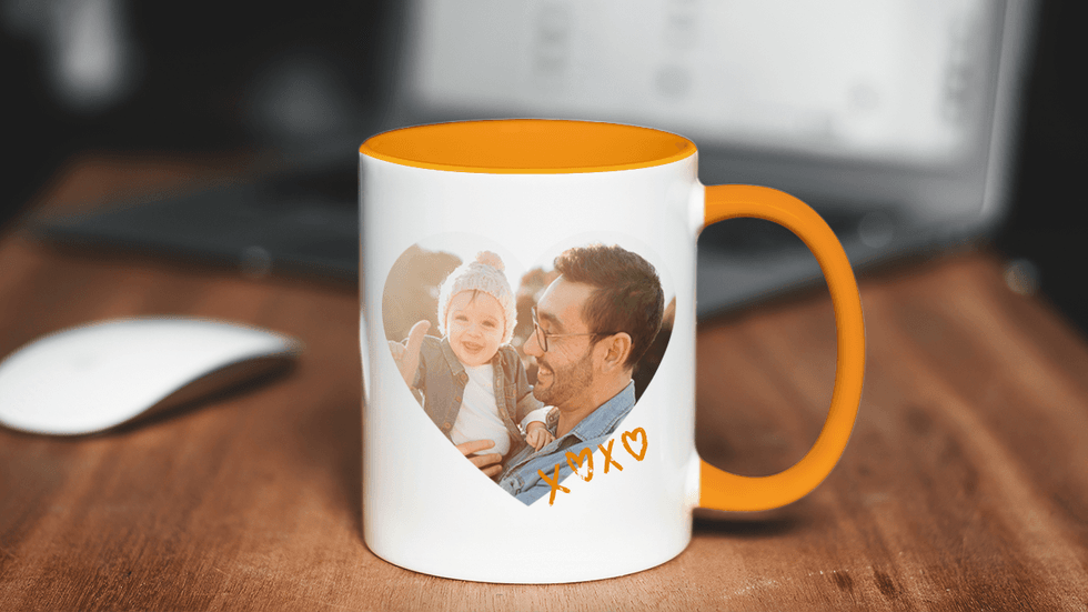 Custom mug with father and child photo on a desk.