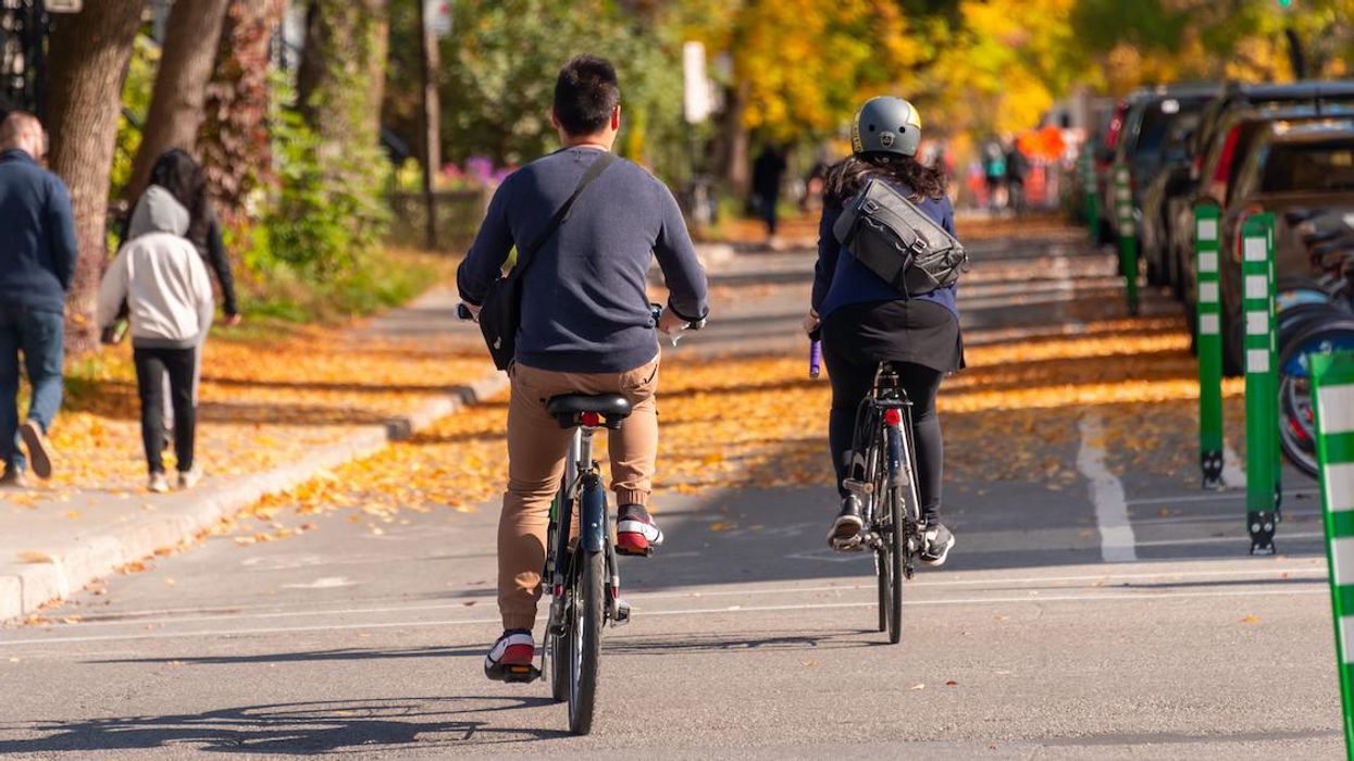 Cyclists on a Montreal bike lane on a fall day.
