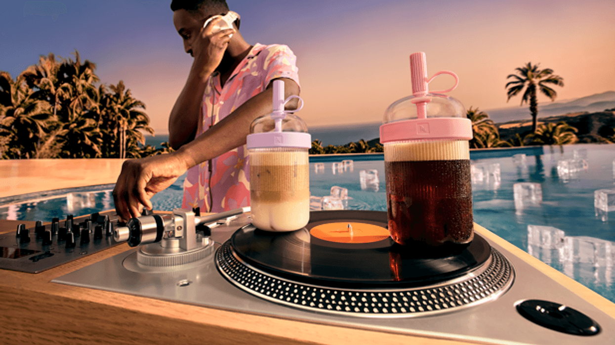 DJ mixing music beside iced Nespresso beverages at a poolside sunset event.