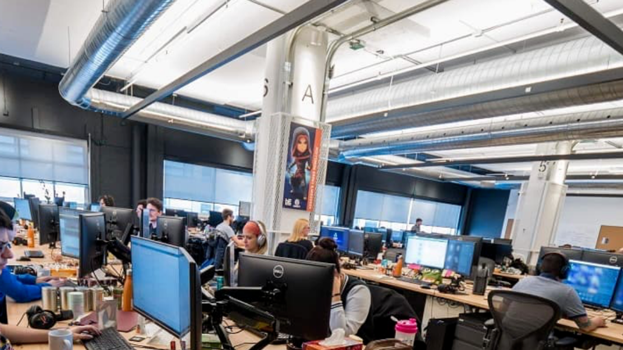 Employees work on computers in the Behaviour Interactive office.