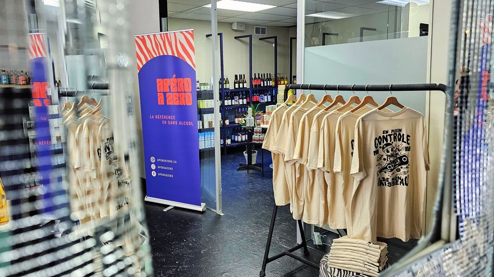 "En plein control de mon vaisseau" shirts designed by David Lavague viewed through the store's disco mirror.