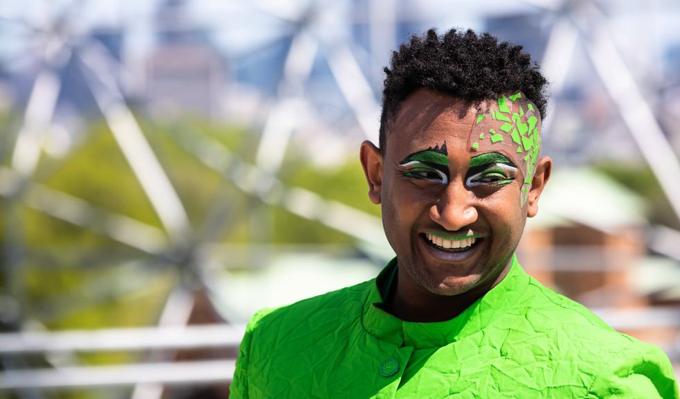 Eye-catching green make-up accents on an acrobat.