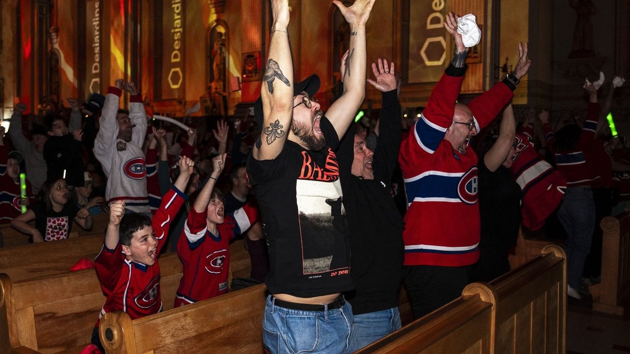 Fans in Montreal Canadiens jerseys cheer inside a church.