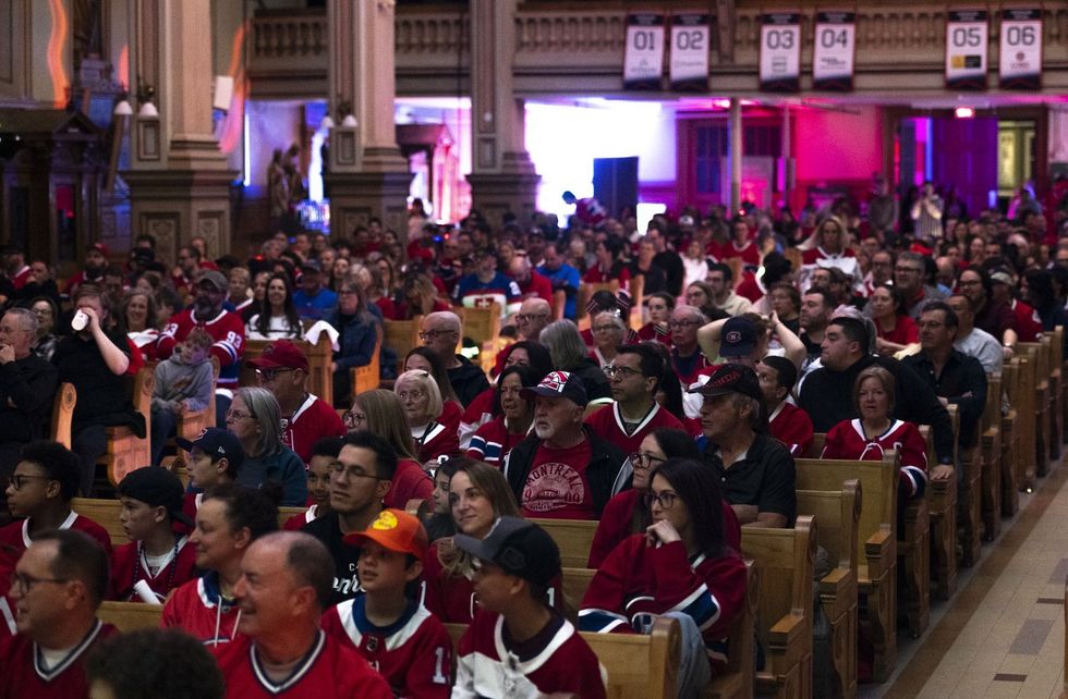 Fans in Montreal Canadiens jerseys gather in a church to watch a playoff game.