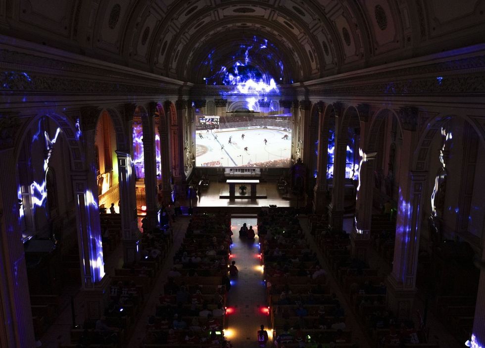 Fans watch the Montreal Canadiens play the Tampa Bay Lightning during NHL playoff hockey action in the Cathedral of Saint-Jean-l'Evangeliste.