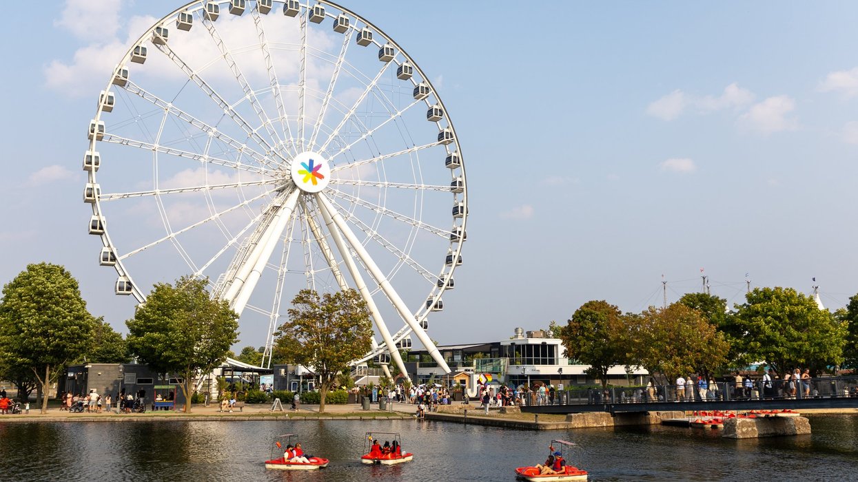 Ferris wheel and pedal boats on water on sunny summer day Montreal, Canada. Montreal, Canada.