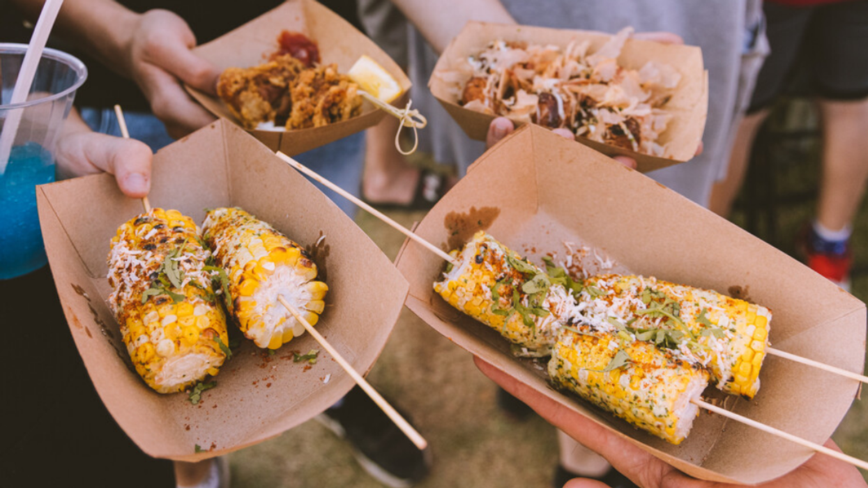 Festival Streetfood Montreal attendees show off their meals.