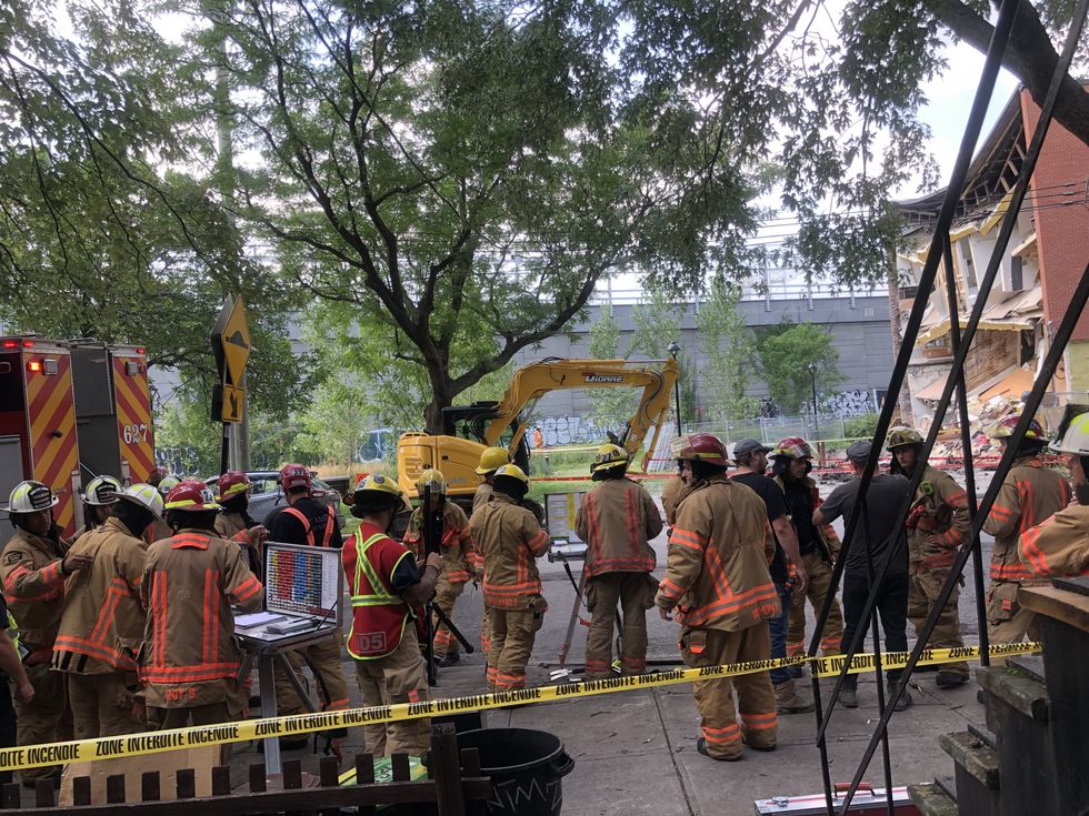 Firefighters at the site of the building collapse.