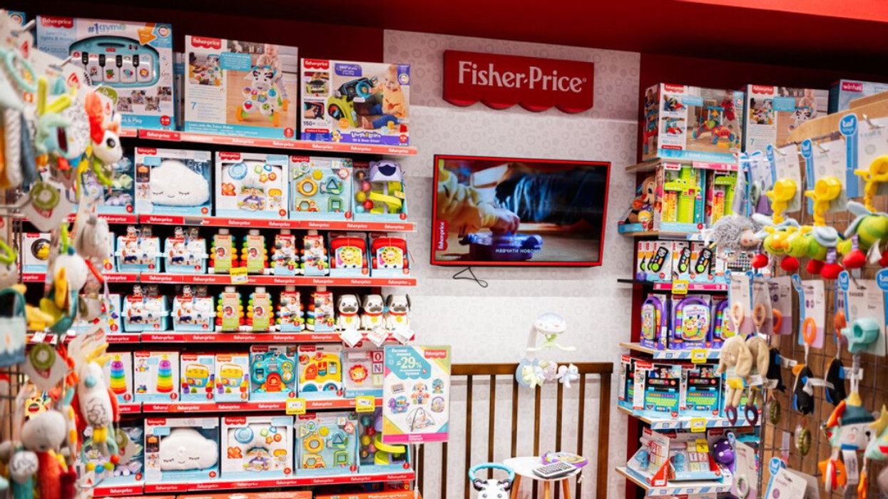 Fisher-Price toy store aisle filled with various children products and decorations.