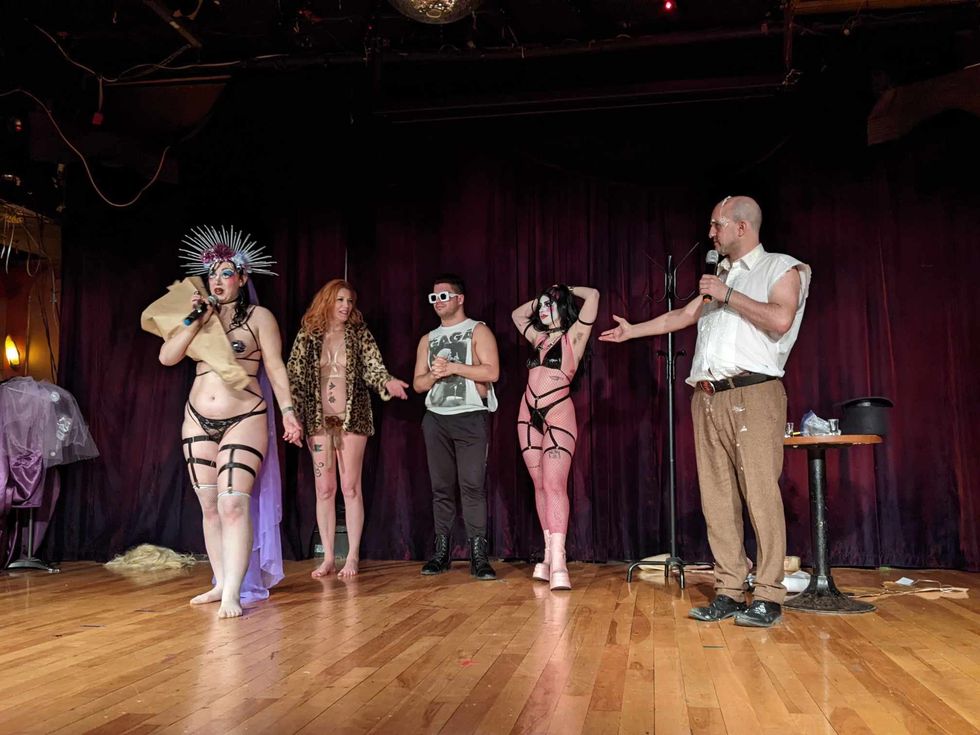 Five performers lined up on stage.