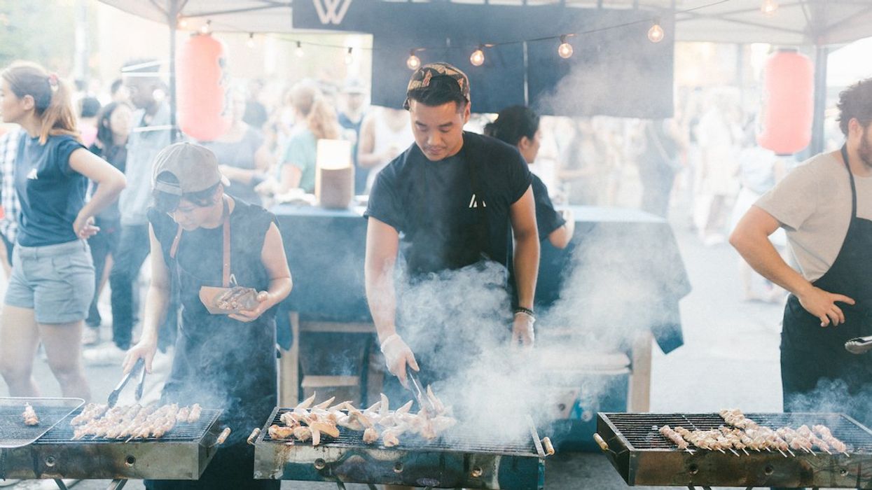 Food vendors prepare grilled meat skewers at YATAI MTL.