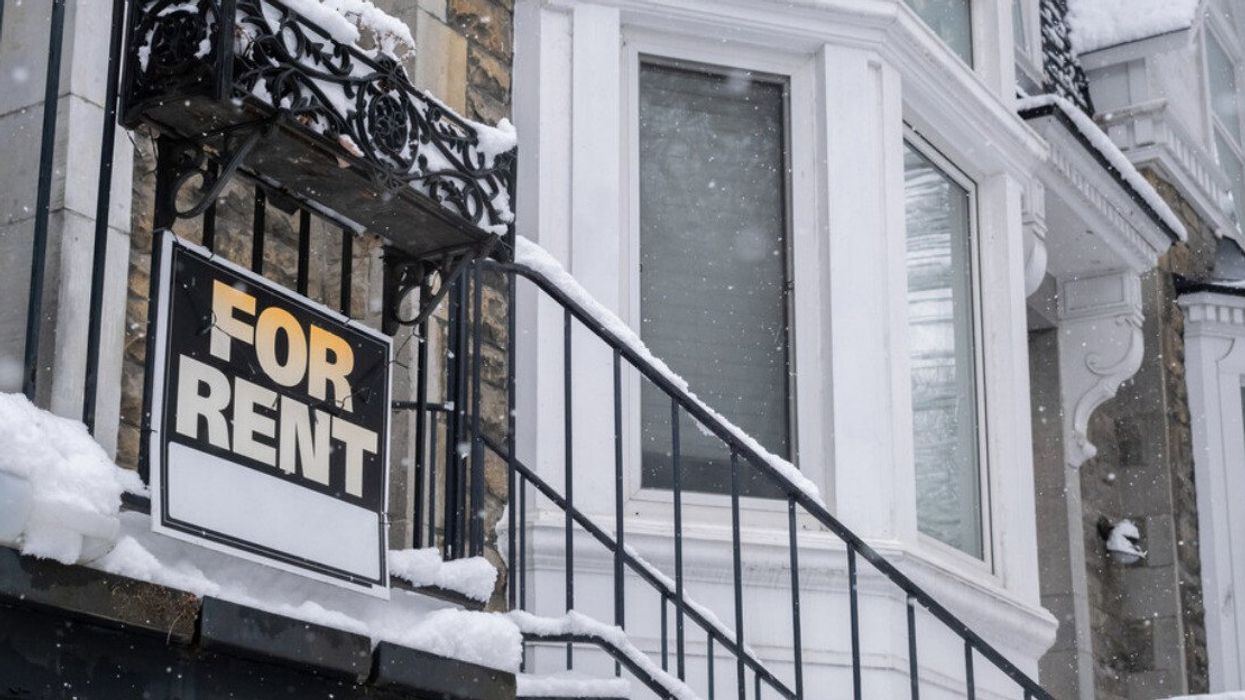 "For rent" sign posted in front of front porch in winter.