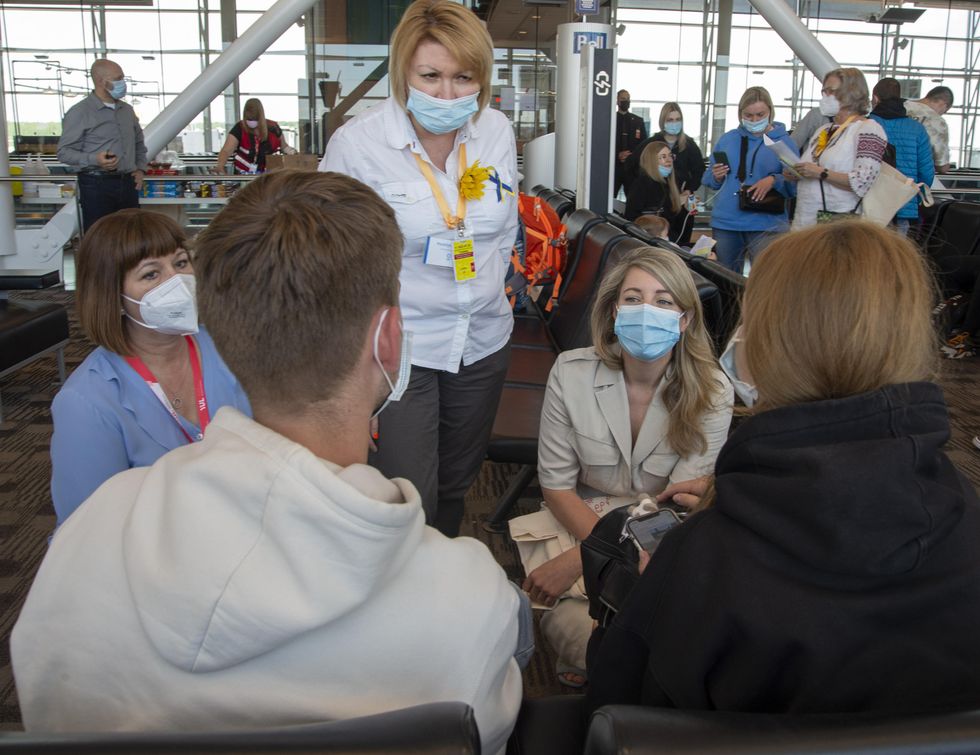 Foreign Affairs Minister M\u00e9lanie Joly greets Ukrainians arriving in Montreal.