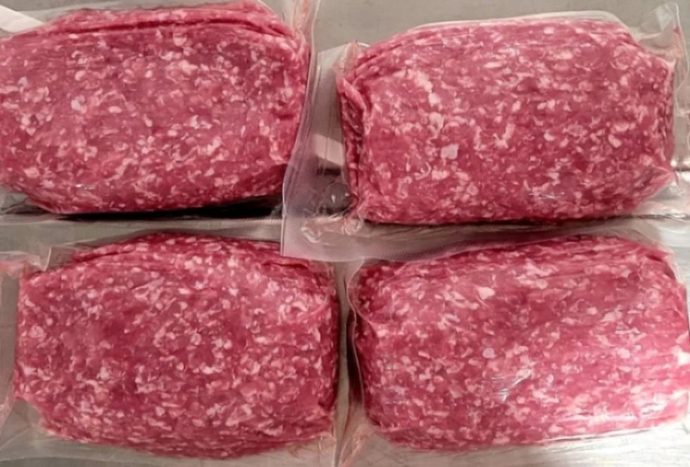 Four packs of ground pork beside one another in plastic packaging.