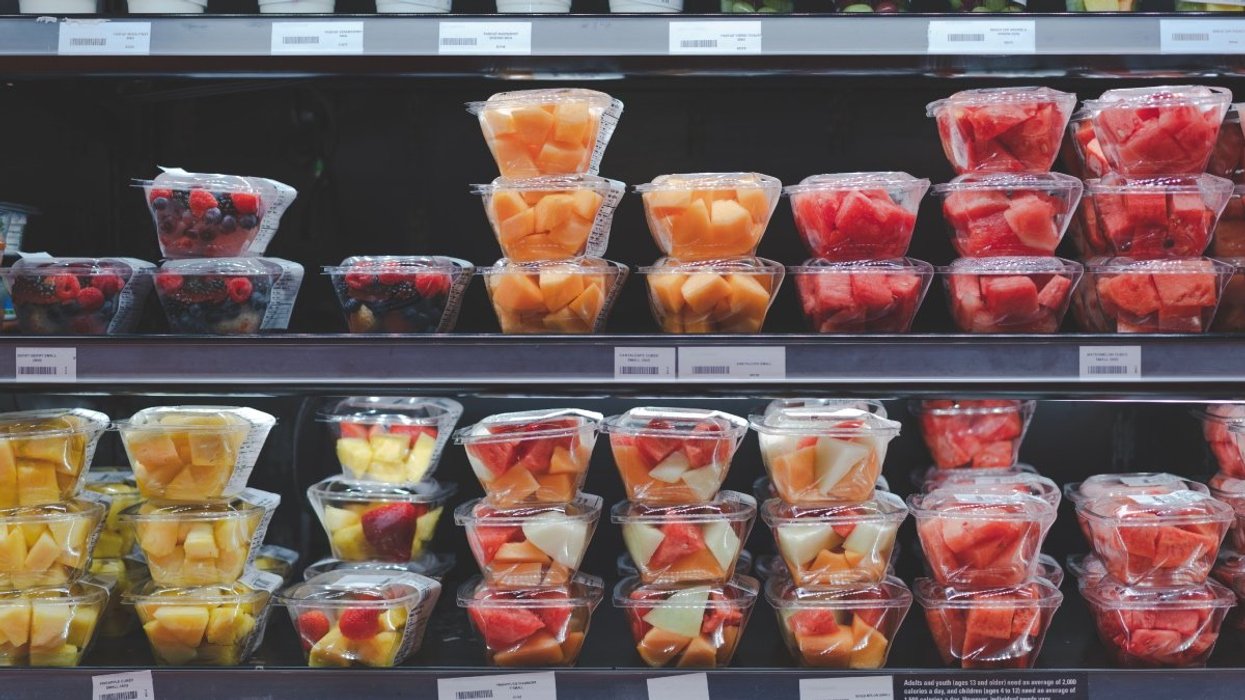 Fresh cut fruit containers stacked in the refrigerator section of a Canadian grocery store.