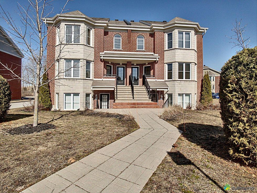 Front of a brick condo building in Longueuil, Quebec.