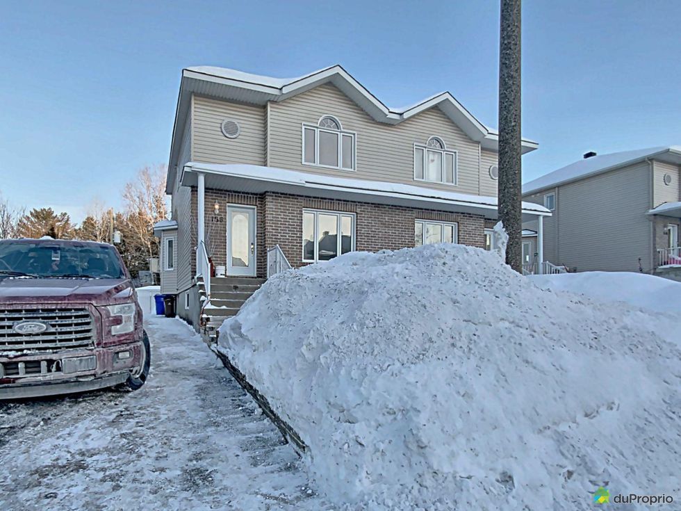 Front of a semi-detached home in Gatineau, Quebec in winter.