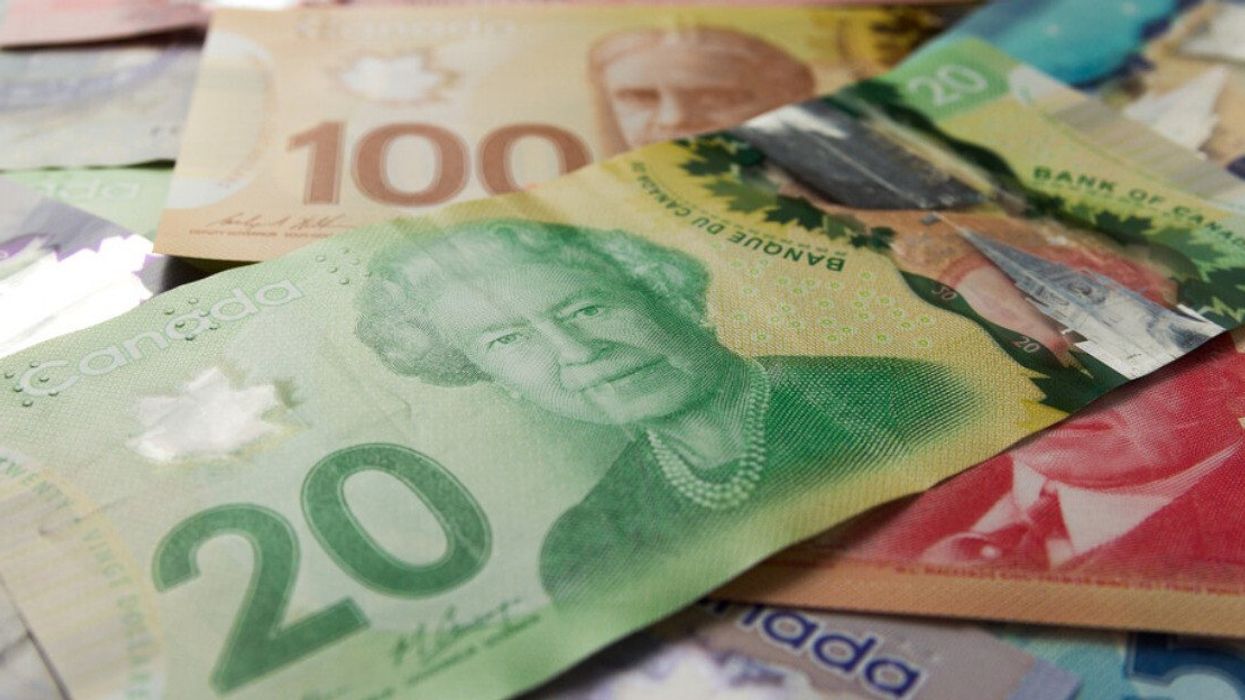 Full frame of bills spread on table and assorted amounts. Canadian currency.
